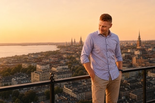 Jacob Westman overlooking Stockholm beside a small Myrmidon ant character at sunset.